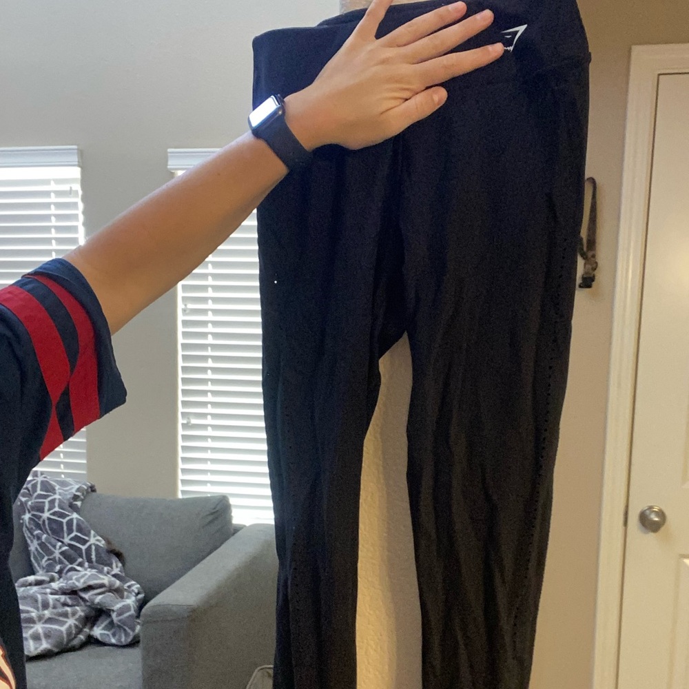 Gymshark black leggings. Design contour holes along thigh and under toosh